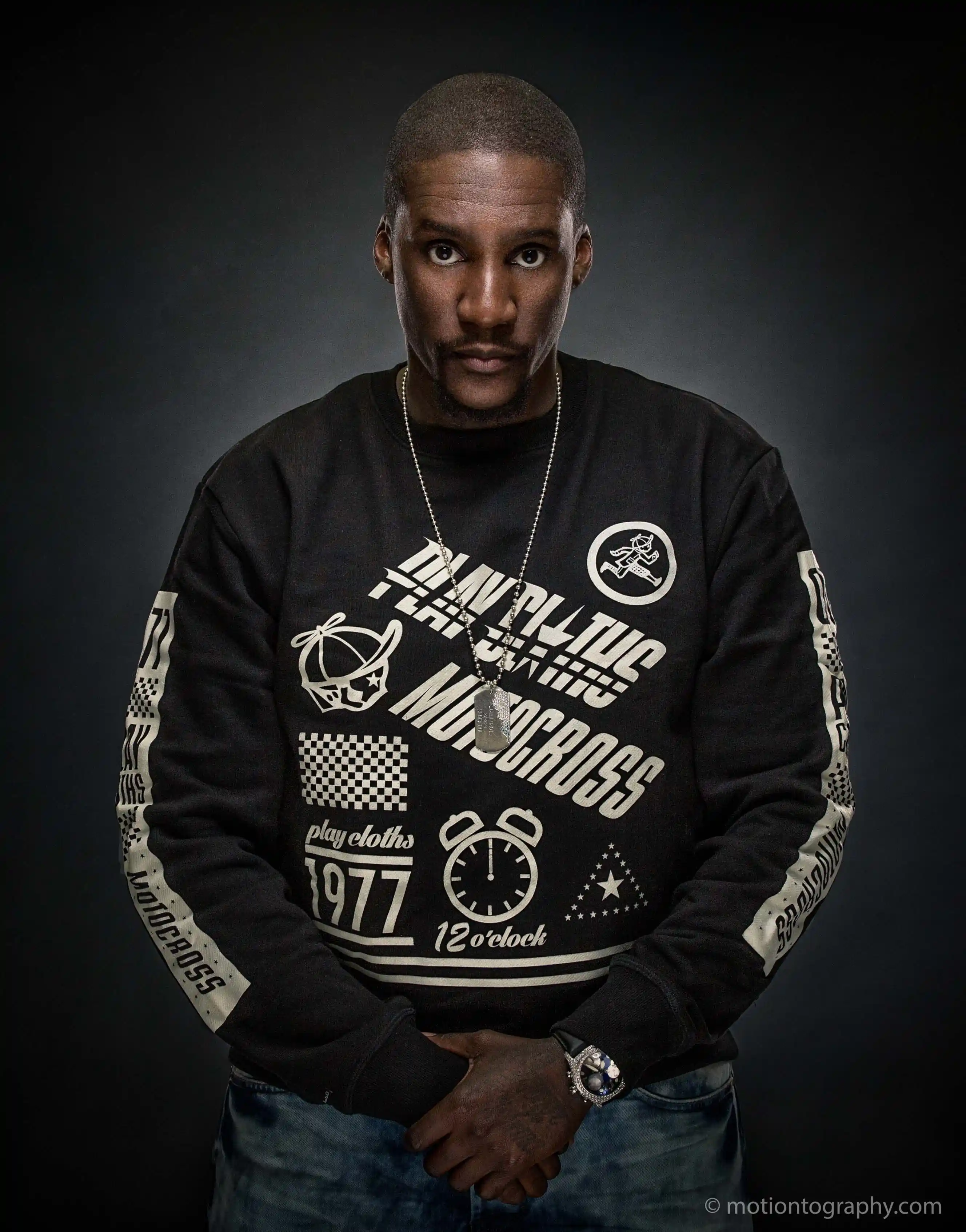 Portrait of rapper No Malice against a plain background