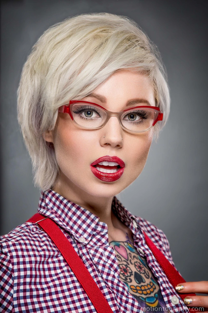 Creative professional headshot with platinum hair and red glasses by Motiontography