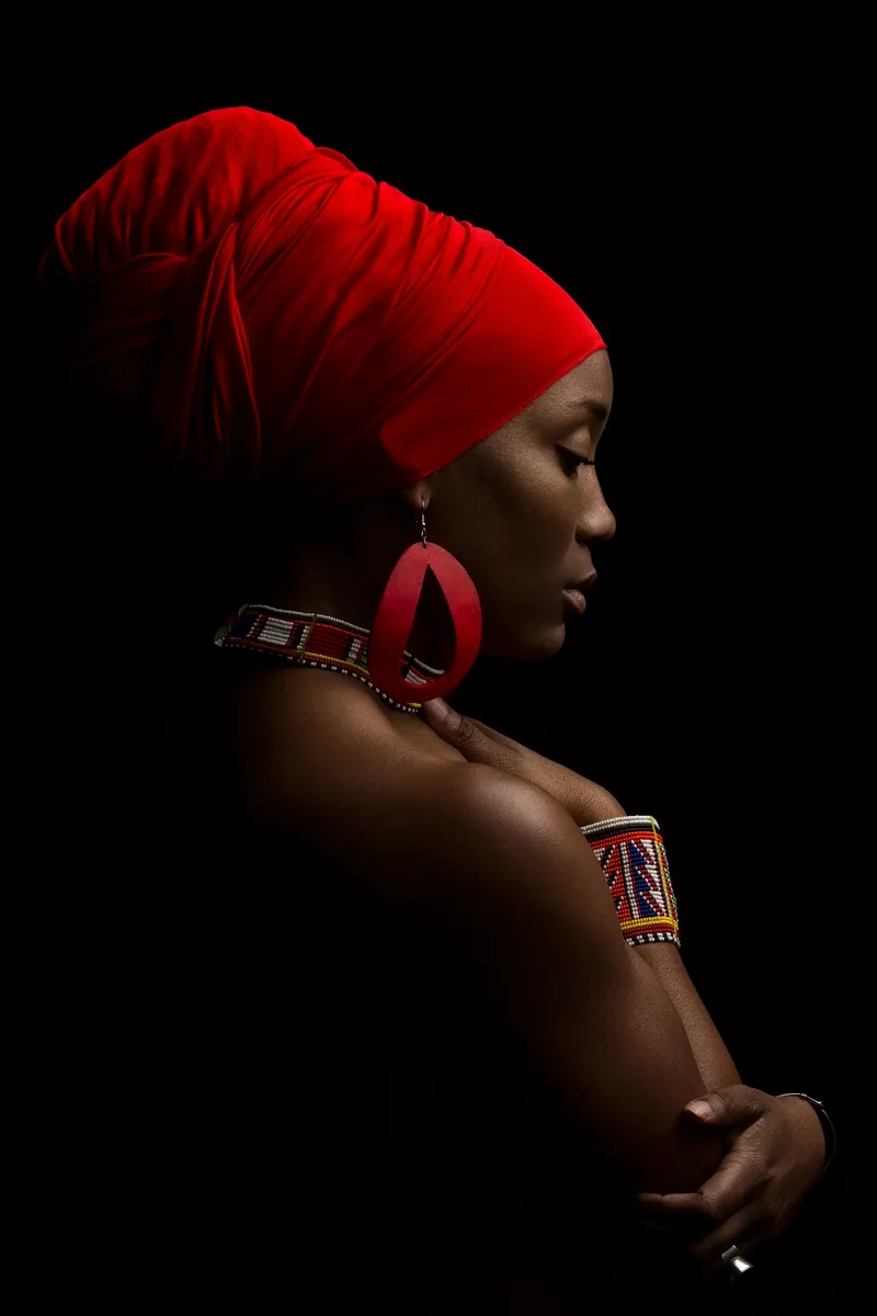 Dramatic profile headshot with red headwrap by Motiontography