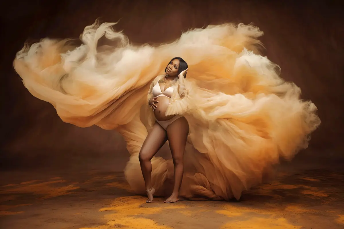 Fine-art maternity portrait with flowing golden fabric by Motiontography in Hampton Roads VA