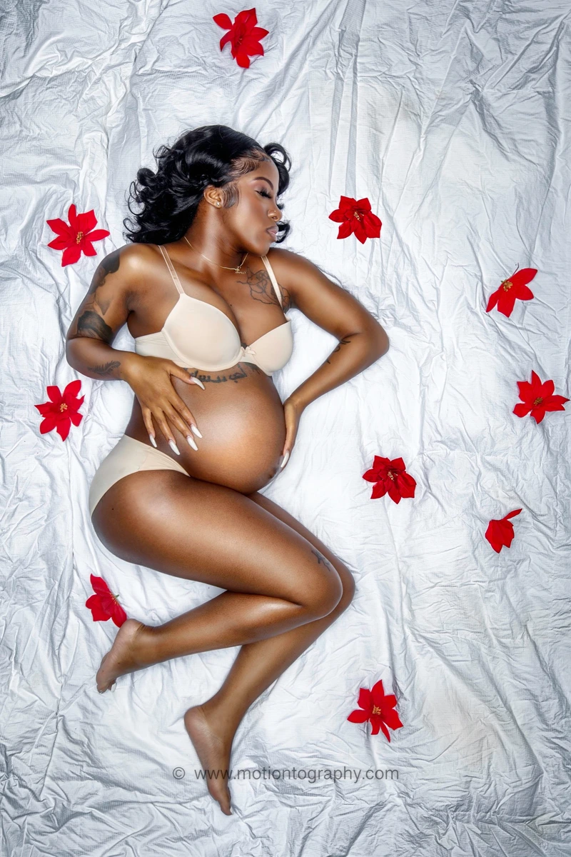 maternity tranquility with red flowers by Motiontography