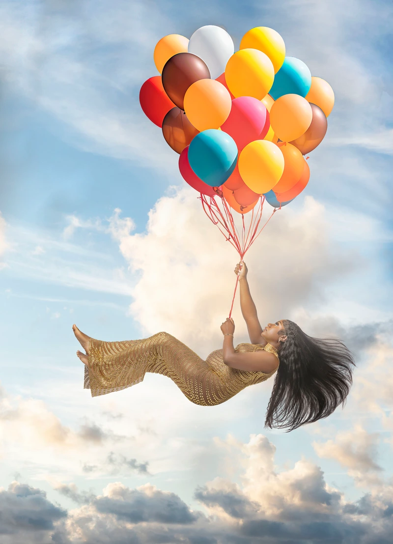pregnant woman gold dress balloon flight by Motiontography
